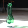 a Benjamin Lintell glass sculpture in green with white detail and a clear glass base.