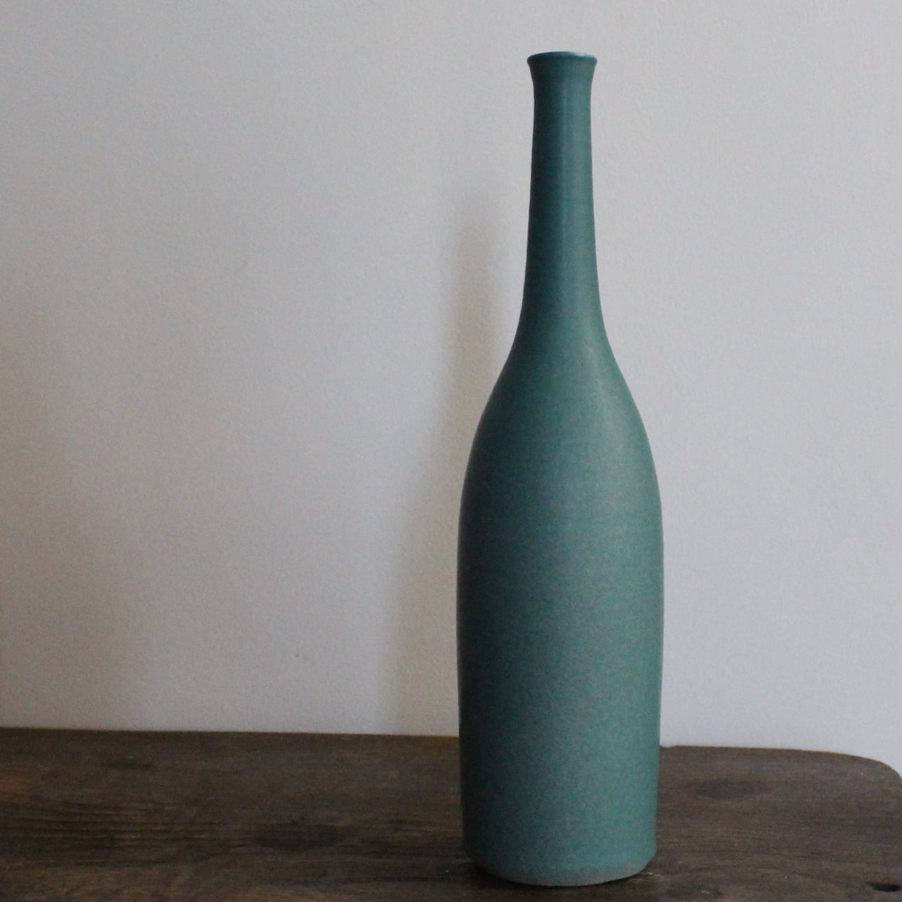 a hand thrown teal coloured ceramic bottle by UK ceramic artist Lucy Burley