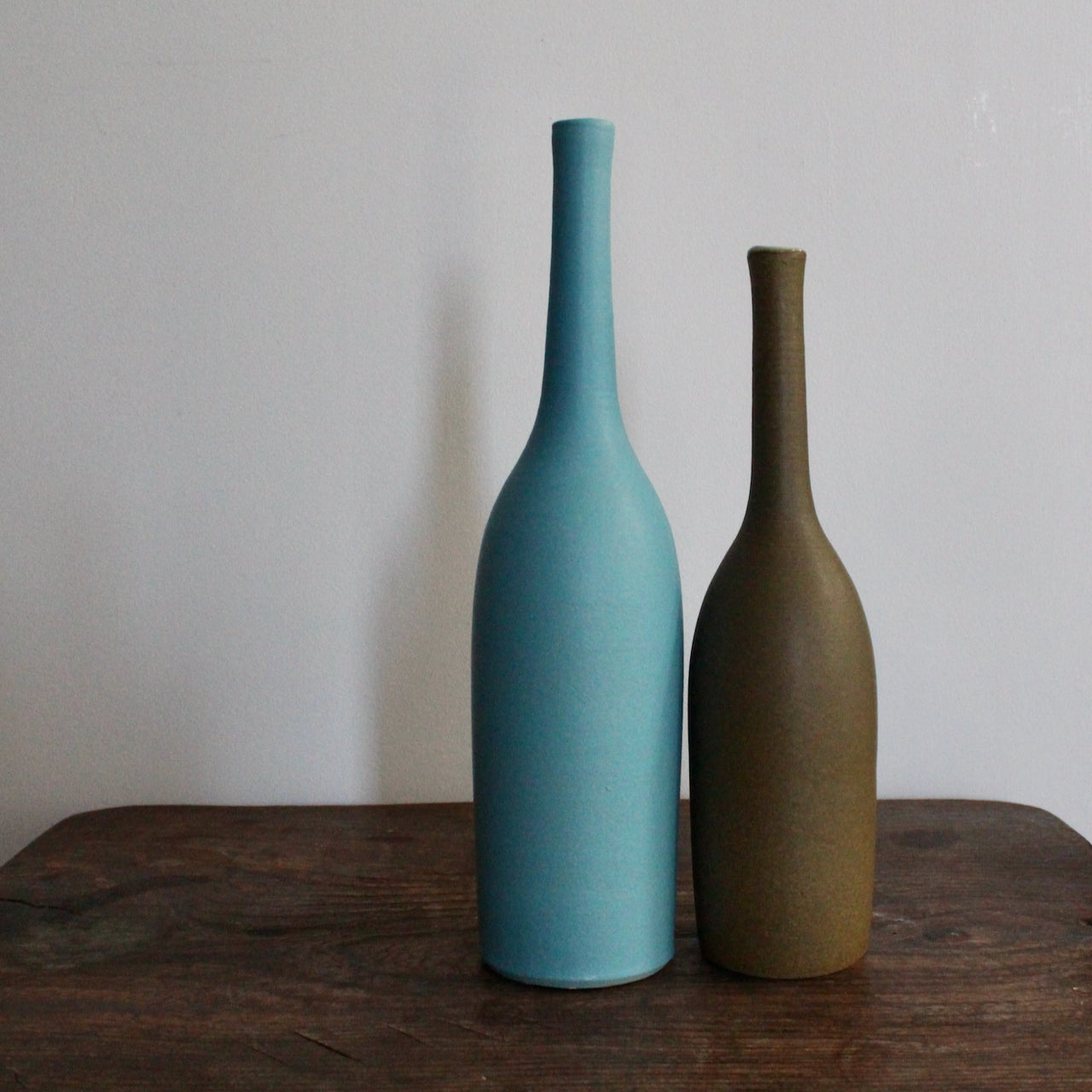 two ceramic bottles by Lucy Burley ceramic artist one is in turquoise glaze and the other olive 