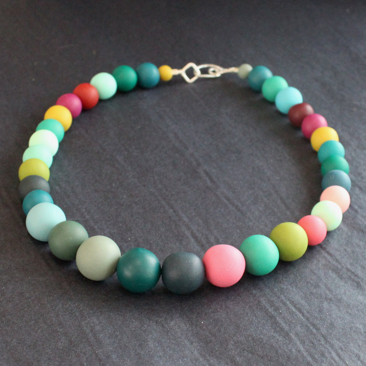 Claire Lloyd necklace of round beads in greens, pinks, blues and yellow 