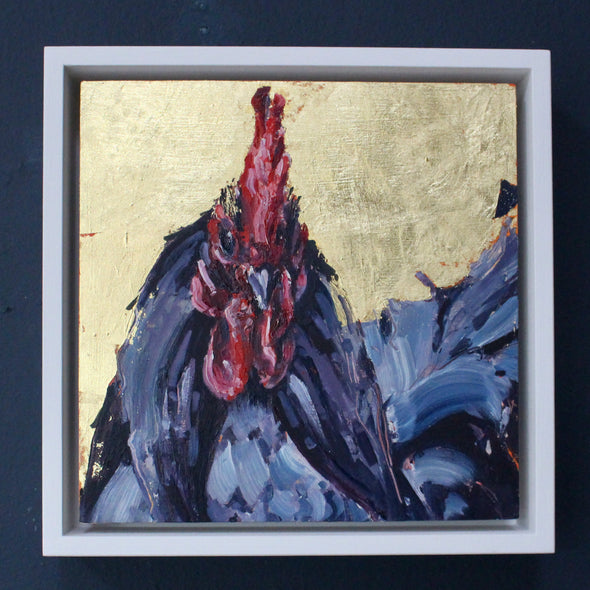 a framed Jill Hudson painting of a cockerel with dark purple feathers and a red head against a gold-leaf background