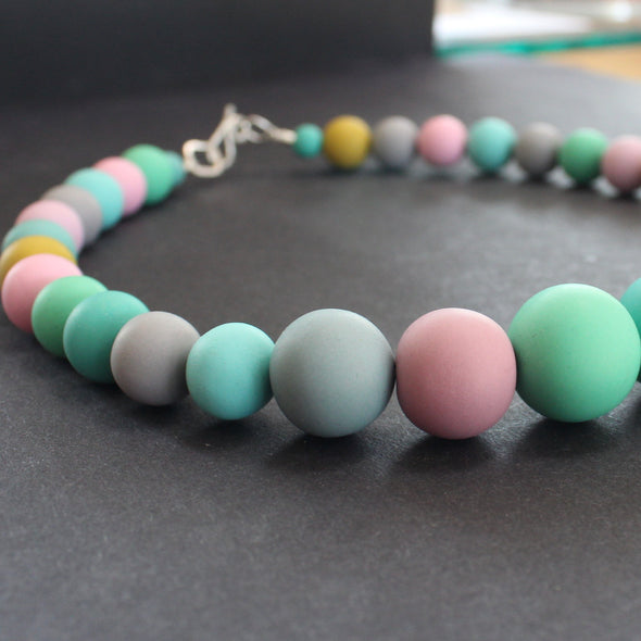 Clare Lloyd - Graduated bead necklace in pastels/mustard