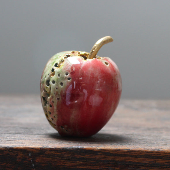red ceramic apple with glaze details and a gold stalk by Cornwall ceramicist Remon Jephcott