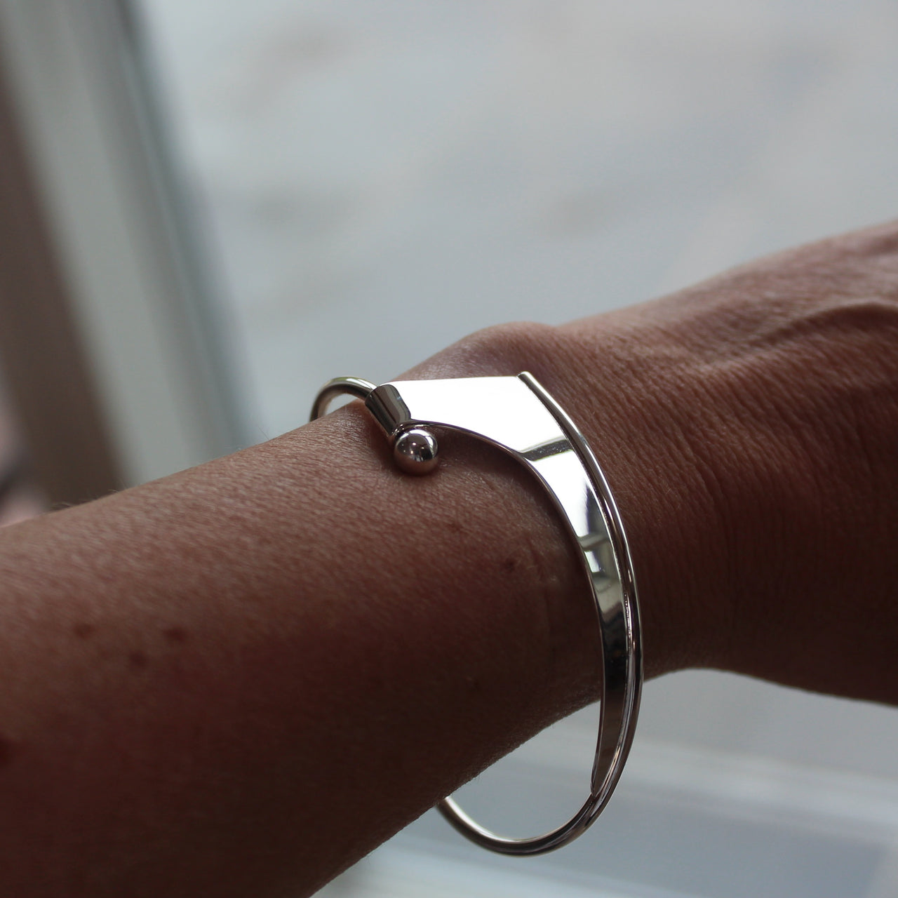 Abstract silver Ancien bangle by Beverly Bartlett on wrist