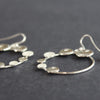 Round silver hoop earrings with small silver circles attached by Beverly Bartlett 