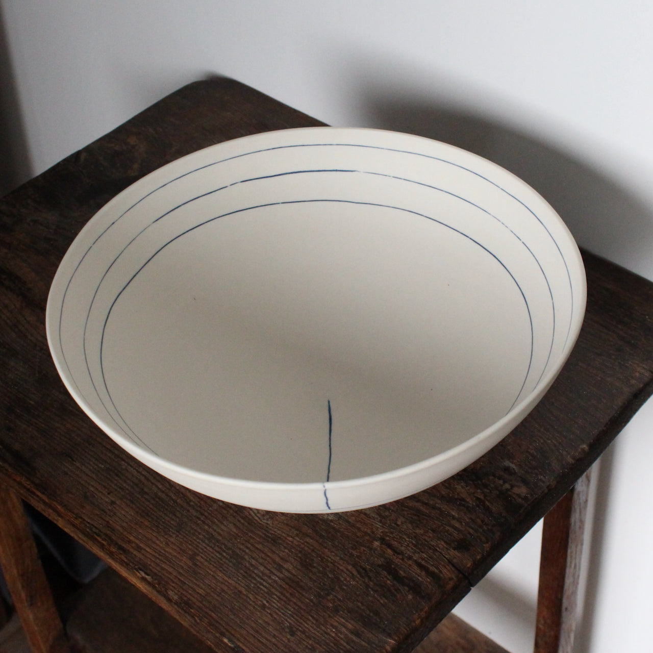 large white porcelain bowl with three blue lines on interior by UK ceramicist Liz O'Dwyer 