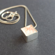 Cube pendant made from silver and cement by Amy Stringer