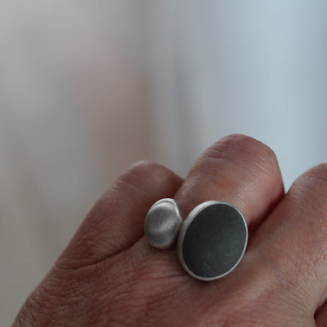 Beach pebble and silver duo ring by Carin Lindberg on finger