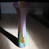 extra tall Ruth Shelley glass vase in shades of pink with central striped section in blues, red and greens. 
