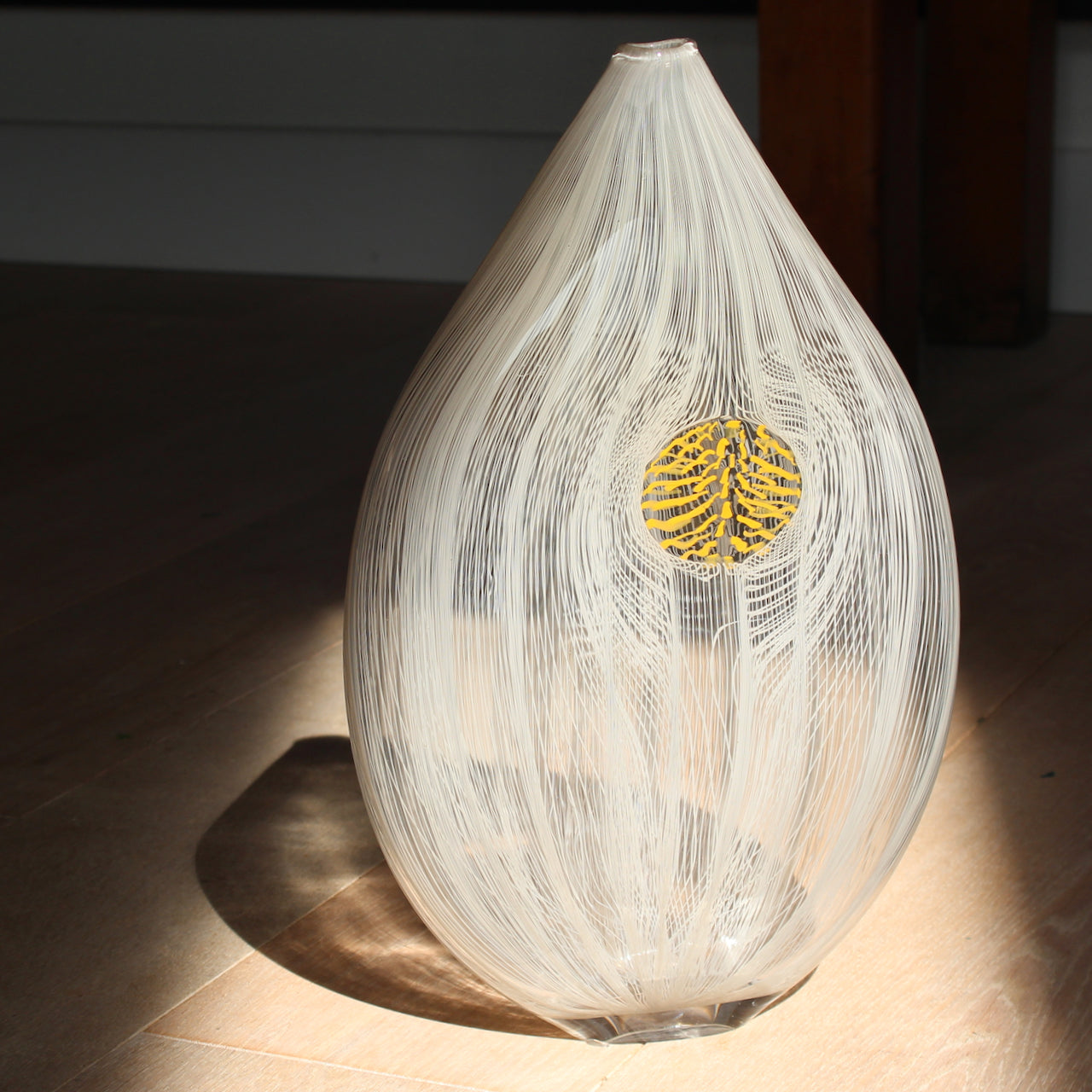 Benjamin Lintell tear shaped glass vase in  white and clear with central yellow detail 