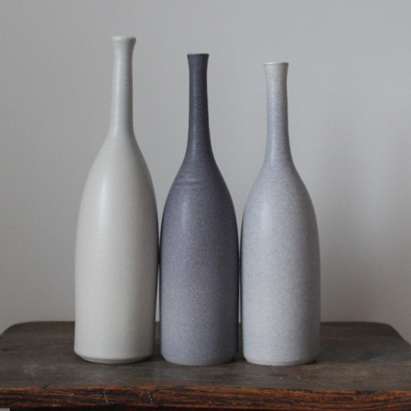 A Trio of ceramic bottles in shades of grey by Lucy Burley. 