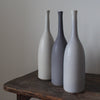 three ceramic bottles in shades of grey by Lucy Burley 