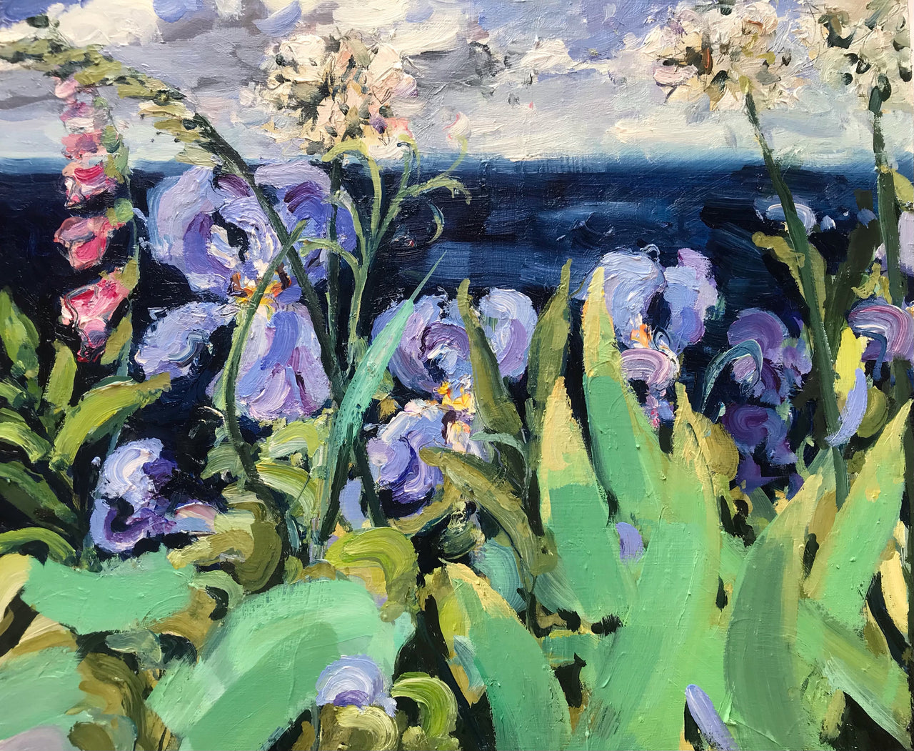 a Jill Hudson oil painting of purple iris flowers and pink lupins in a garden overlooking a blue sea