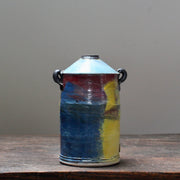 ceramic vase with a tapered top and small lug handles by John Pollex, leading British ceramicist, it is multi coloured with a blue top.
