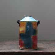 ceramic vase with a tapered top and small lug handles by John Pollex, leading British ceramicist, multi coloured, it has  a blue top.