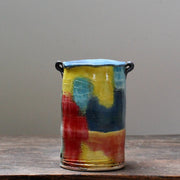 ceramic vase with a tapered top and small lug handles by John Pollex, British potter, it is multi coloured with a blue top.