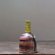 small ceramic bottle by leading UK ceramicist John Pollex it has an abstract decoration and a long yellow neck