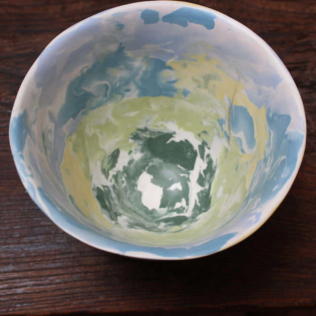 the inside of a A tall porcelain bowl made of blue and yellow coloured clay in the Nerikomi style by ceramicist Judy McKenzie.