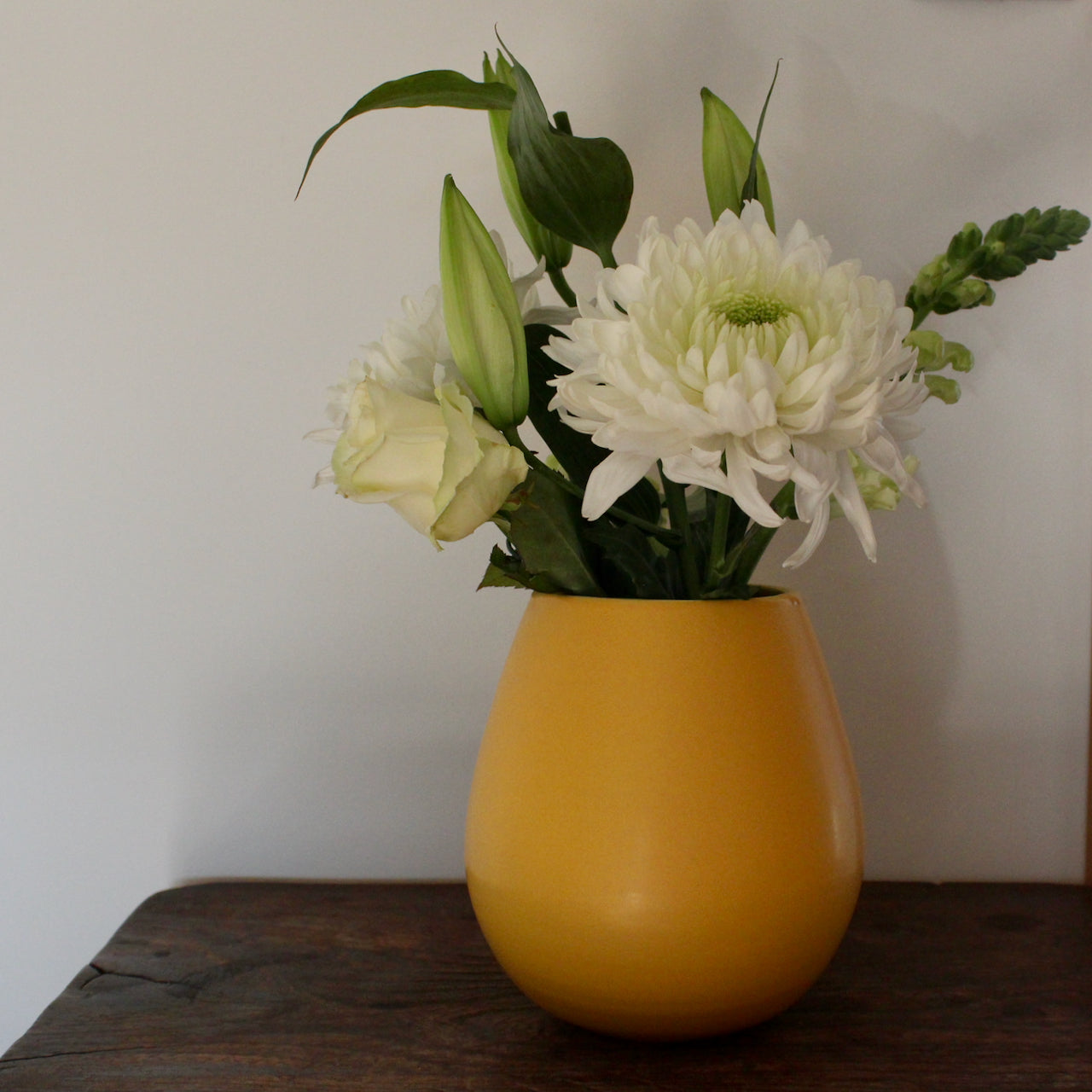 golden yellow ceramic vase with white flowers in it UK ceramicist Lucy Burley