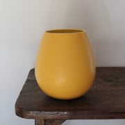 a golden yellow ceramic vase  UK ceramicist Lucy Burley.