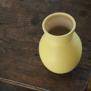 a yellow vase by UK ceramic artist Lucy Burley.