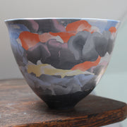 porcelain Nerikomi style bowl in dark purple, orange and yellow by ceramic artist Judy Mckenzie