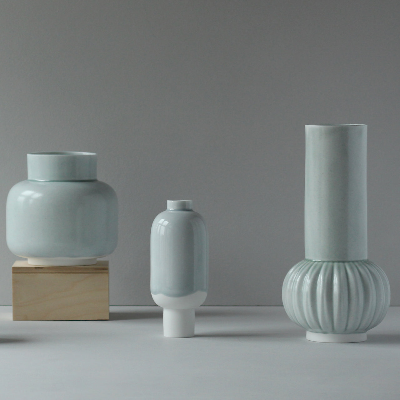 Three pale green ceramic vases