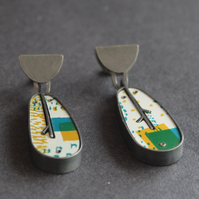 leaf shaped earrings in silver and printed aluminium in yellow and green  by jeweller Lindsey Mann