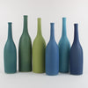 Lucy Burley ceramic bottle collection in shades of blue from petrol  blue to turquoise 