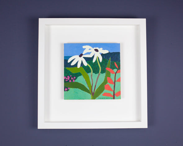 painting of two white flowers on a background of green grass and blue sky; in a white frame on a dark wall