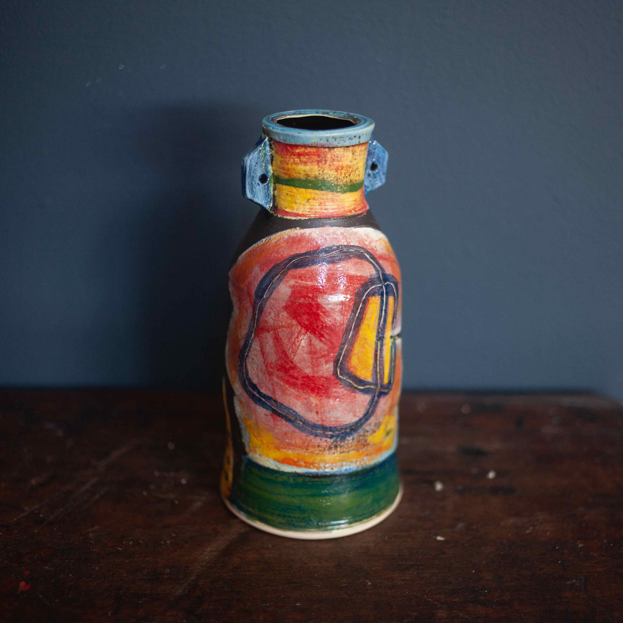 Ceramic vase in reds, greens and blues by John Pollex