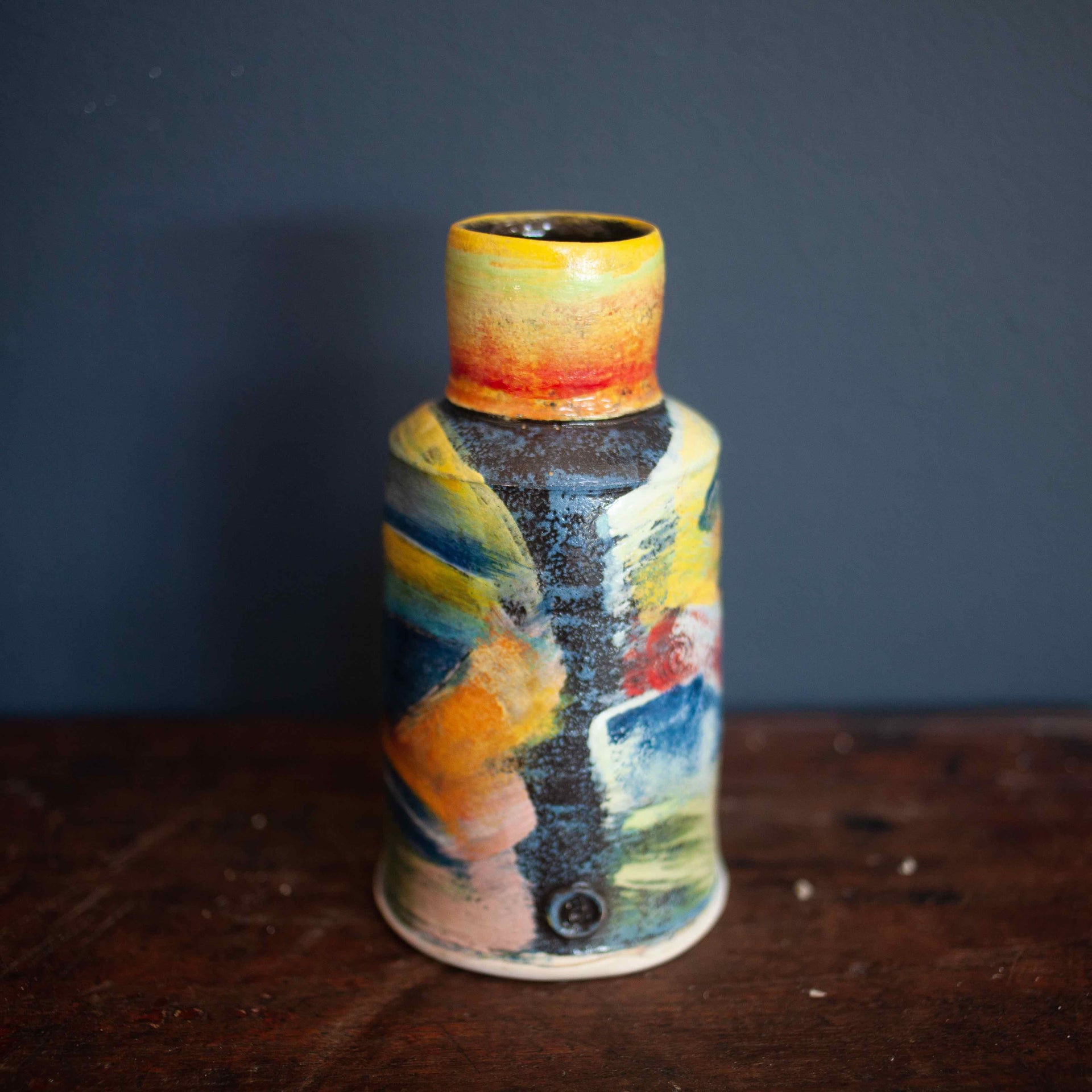 Colourful vase by John Pollex with narrow top