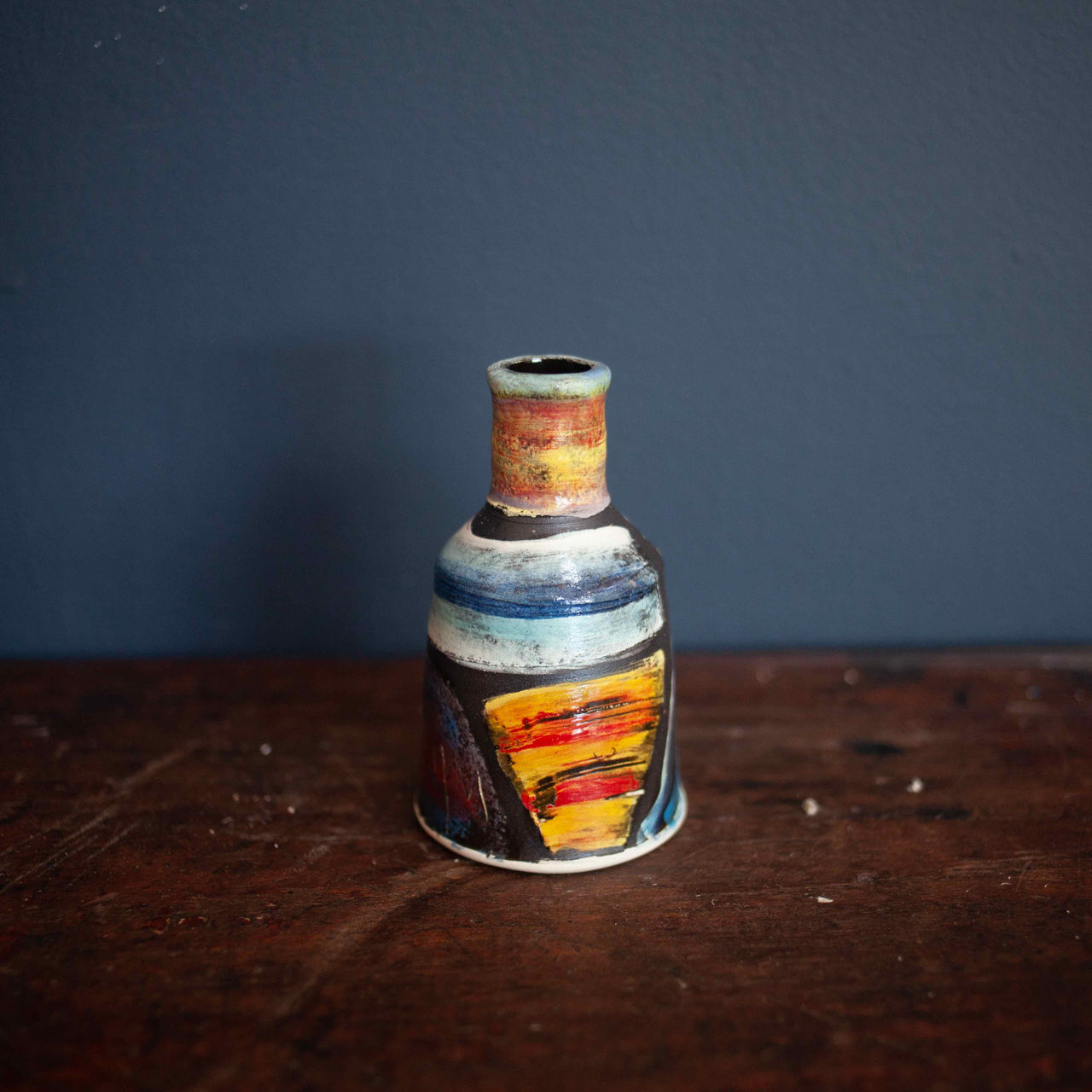 A Small red and blue ceramic bottle