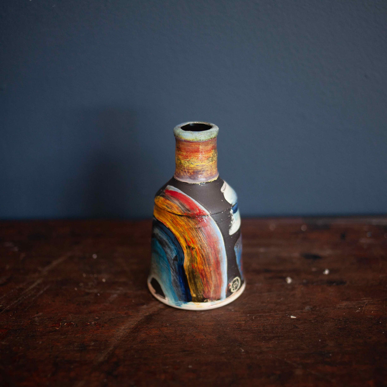 Small red and blue ceramic bottle