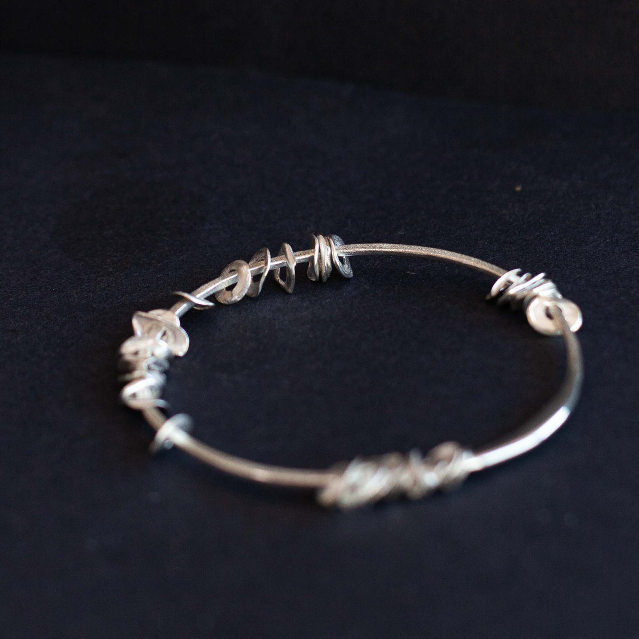 Silver sea siren bangle with silver pieces by Claire Stockings-Baker 