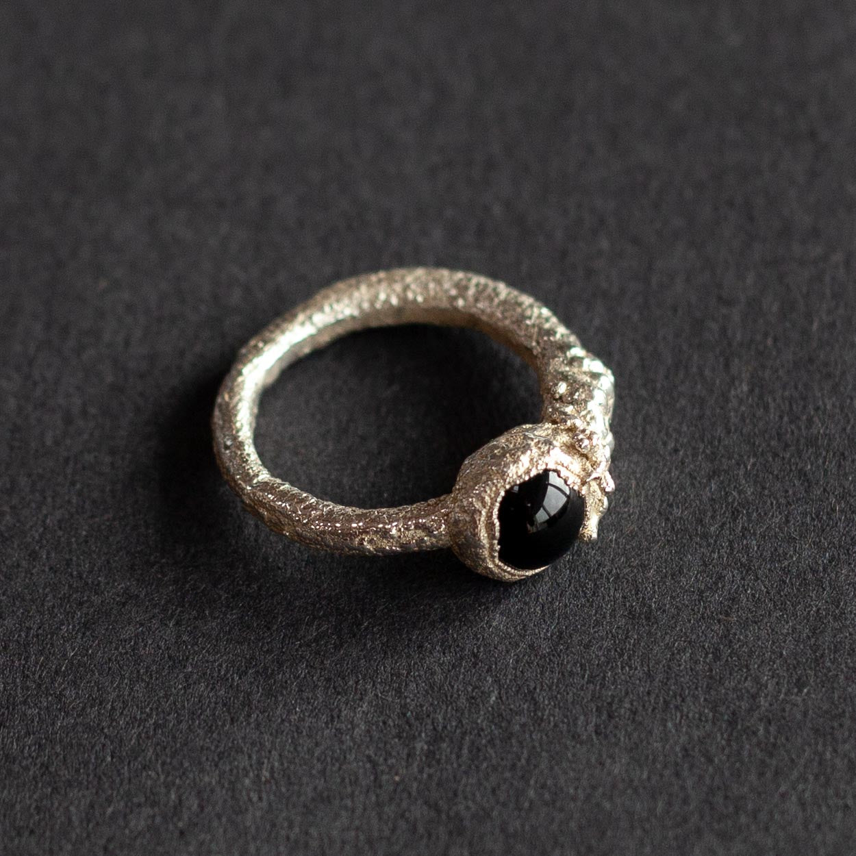 a textured silver ring with dark blue stone by jeweller Libby Ward.