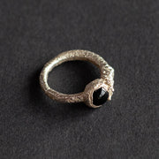 a textured silver ring with dark blue stone by jeweller Libby Ward.