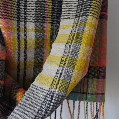 Close up of handwoven scarf with orange, yellow  colours 