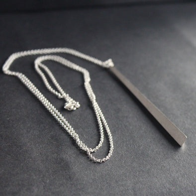silver pendant with a long chain by beverly bartlett