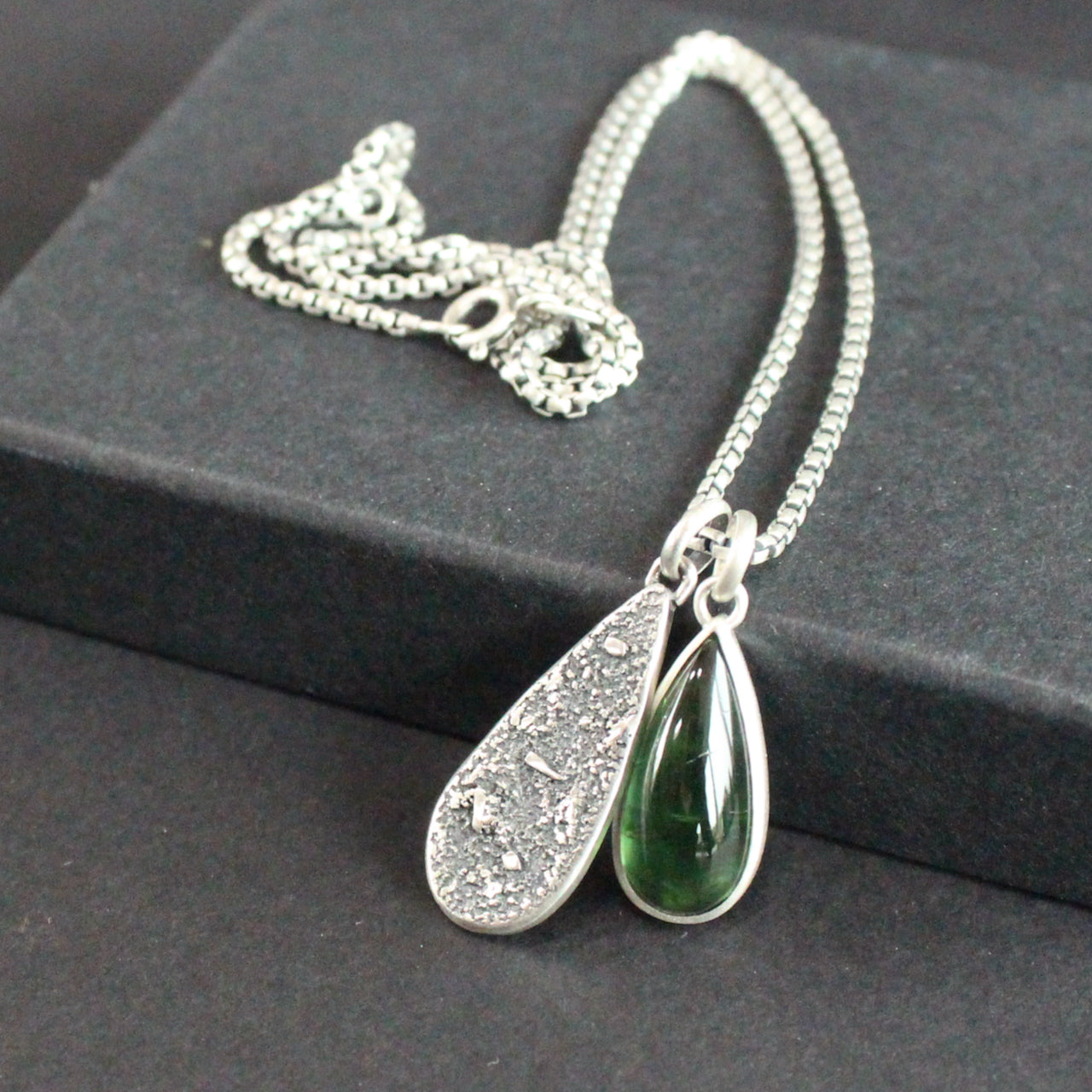 Carin Lindberg - Green tourmaline and textured silver duo pendants close up
