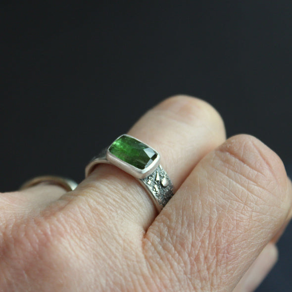 Carin Lindberg - Green tourmaline ring in textured sterling silver woman wearing on middle ring left hand