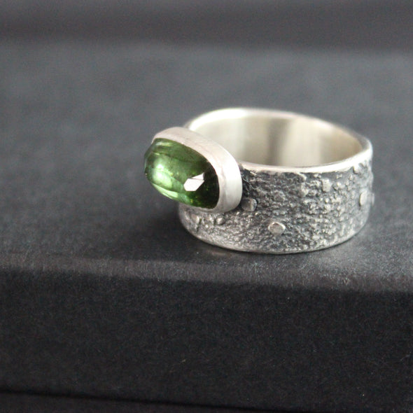 Carin Lindberg - Green tourmaline ring in textured sterling silver close up 2 on raised display box