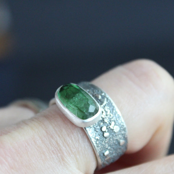 Carin Lindberg - Green tourmaline ring in textured sterling silver being shown worn on it's own.