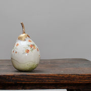 large ceramic white pear with orange floral detail and a gold stalk by Remon Jephcott