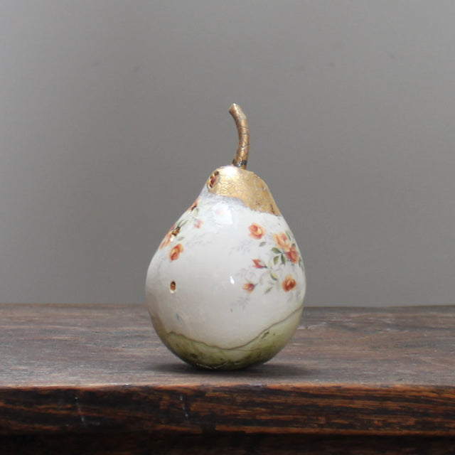 large ceramic white pear with orange floral detail and a gold stalk by Remon Jephcott. 