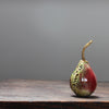 ceramic red and green pear and a gold stalk by Cornwall ceramicist Remon Jephcott.