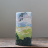 a multicoloured ceramic vase in greens, blues, white and pink in the Nerikomi style by ceramic artist Judy McKenzie