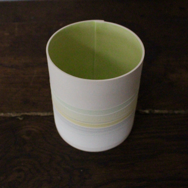 ceramic pot with pastel line decoration and pale green interior