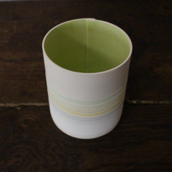 ceramic pot with pastel line decoration and pale green interior 