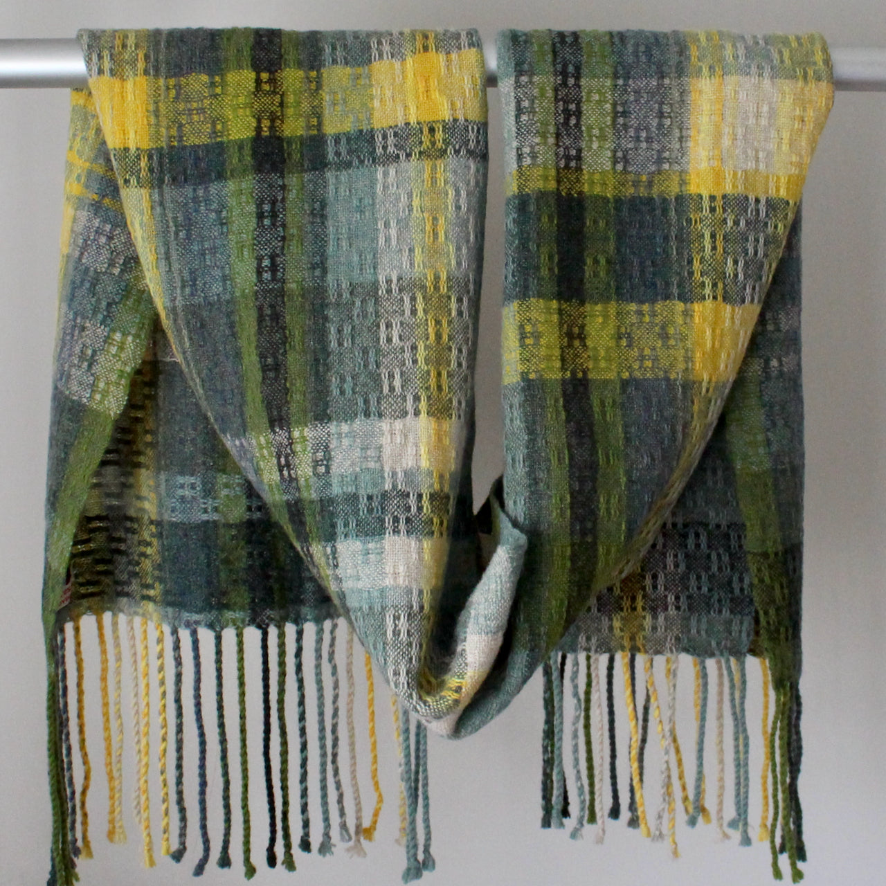 Cornish textile designer Teresa Dunne's hand-woven scarf in shades of blue, green and yellow